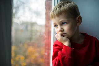 Boy staring out of a window