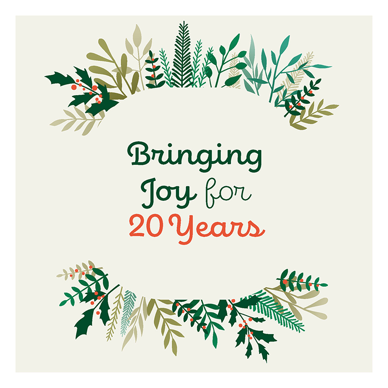 Text "Bringing Joy for 20 years" surrounded by fern and holly sprigs